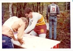 Two People Writing on Table in Woods (Part of the NMU Historic Photographs Collection)