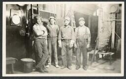 (020-003) Four Men Posing in front of Ladders