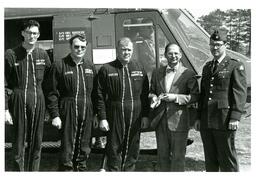 John X. Jamrich Giving Award to Four Men in Military Uniforms in Front of Helicopter (Part of the NMU Historic Photographs Collection)