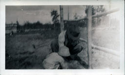 Father and Son Fixing Fence