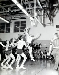 (585-05) Basketball--NMC vs. Michigan Tech at Michigan Tech Feb. 22, 1961: College Basketball Players Shooting the Ball Towards Net