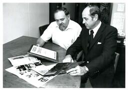 Two Men Looking at Plaque and Books (Part of the NMU Historic Photographs Collection)