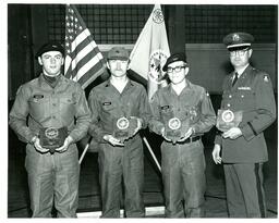 Chiapuzio, McKevitt, Crocker, and Unknown Man Posing with Awards (Part of the NMU Historic Photographs Collection)