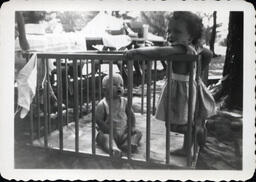 Two Toddlers in Outside Play Pen