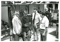 Three Men with Welding Students (Part of the NMU Historic Photographs Collection)