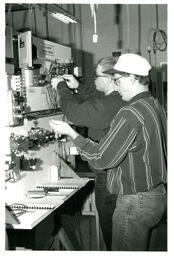 Two People Working with Motor Control Trainer (Part of the NMU Historic Photographs Collection)