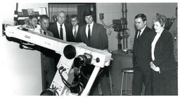 Group of People Looking at Robotic Arm (Part of the NMU Historic Photographs Collection)