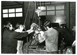 Four Students Using Chain to Lift Engine Block (Part of the NMU Historic Photographs Collection)