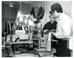 Three Students Working with Machinery (Part of the NMU Historic Photographs Collection)