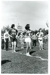  Marching Band Doing Stretches with Position Numbers Strapped to Chest (Part of the NMU Historic Photographs Collection)