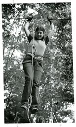 Student Walking on Tightrope in Forest (Part of the NMU Historic Photographs Collection)