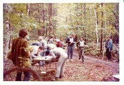 Group of Competitors Writing on Tables in Woods (Part of the NMU Historic Photographs Collection)