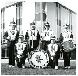 Six Marching Band Members Posing in front of Thomas Fine Arts (Part of the NMU Historic Photographs Collection)