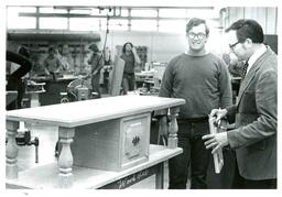 Professor Looking at Student’s Carpentry Project (Part of the NMU Historic Photographs Collection)