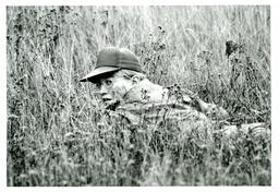 Student Crawling through Brush in Military Uniform (Part of the NMU Historic Photographs Collection)