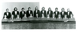 Choir in Matching Formal Clothes Posing behind Banquet Tables (Part of the NMU Historic Photographs Collection)