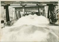 Flood Waters Rushing under Bridge