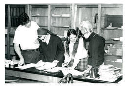 Nun and Three Other People Looking at Papers (Part of the NMU Historic Photographs Collection)