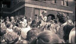 (008-008) Group of People Gathered Around Woman Holding Baby