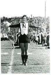 Cheerleader Performing in front of Marching Band (Part of the NMU Historic Photographs Collection)