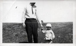 Young Tom Ross Holding a Man's Hand