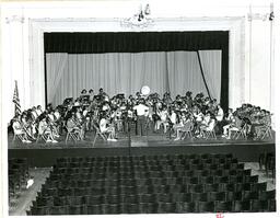 Children’s Concert Band Practicing on Stage in Empty Auditorium (Part of the NMU Historic Photographs Collection)