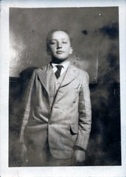 Boy in Three-Piece Suit Eyes Camera