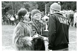 The Golden Girl and Robert Glenn Handing Trophies to Man with UCMC Jacket (Part of the NMU Historic Photographs Collection)