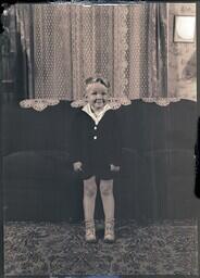 (048-005) The Youngest Chabot Standing in Front of Couch