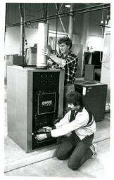 Two Students Working on Machine (Part of the NMU Historic Photographs Collection)