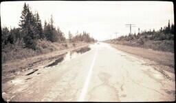 (024-004) Car Driving Down M-64 after Flood