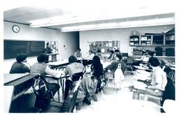 Professor Giving Lecture to Driving Students in Room with Model Car (Part of the NMU Historic Photographs Collection)