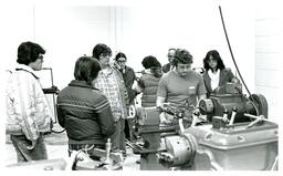 Group of People Watching Man Work with Machine (Part of the NMU Historic Photographs Collection)