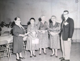 Alumni Activities Summer 1960: Four Women, One Man Standing With Papers