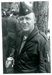 Man in Military Uniform Holding Sprite (Part of the NMU Historic Photographs Collection)