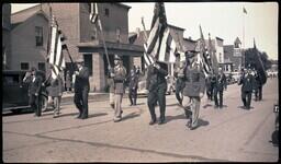 (008-044) Men with Flags and Guns Marching in Ontonagon Fourth of July Parade