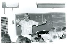 Music Teacher Directing Concert Band of Young Students (Part of the NMU Historic Photographs Collection)