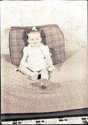 (073-002) Young Girl Posing on Cushion (1 of 2)