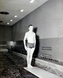 Swimming Team: Diver Backwards on Edge of Board