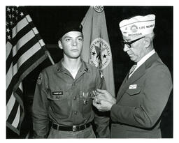 Cadet Thompson Receiving Medal from Man in Suit and Military Cap (Part of the NMU Historic Photographs Collection)