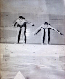 Swimming Team: Two Swimmers Prepare to Enter Water (Front)