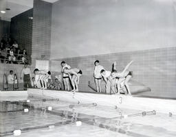 Swimming Team: Three Swimmers Prepare to Enter Water (Side)