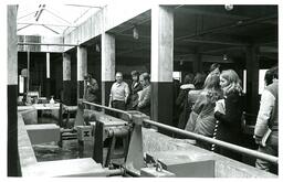 Group of People Looking at Machine with Water Flowing through It (Part of the NMU Historic Photographs Collection)