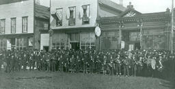 Iron Mountain band in front of Rundle Bros. Hardware and Seibert's Drug Store