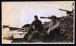 Two Men Sitting on Log