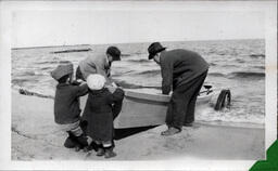 Adults and Children Launching a Rowboat