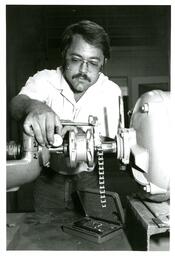 Man Using Machine to Make Chain Links (Part of the NMU Historic Photographs Collection)