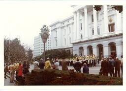 Marching Band Performing in front of Tall Building with Palm Trees (Part of the NMU Historic Photographs Collection)