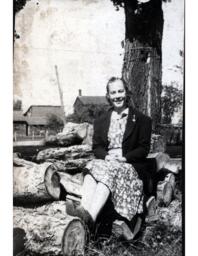 Girl Sitting on Woodpile