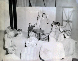 (622-07) Masquers--"Enemy of the People" 1959: Group of People Surrounding Man on Stage